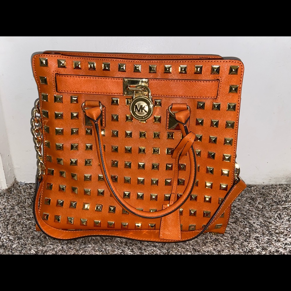 Vintage gold studded Michael Kors large tote in orange with dust bag.